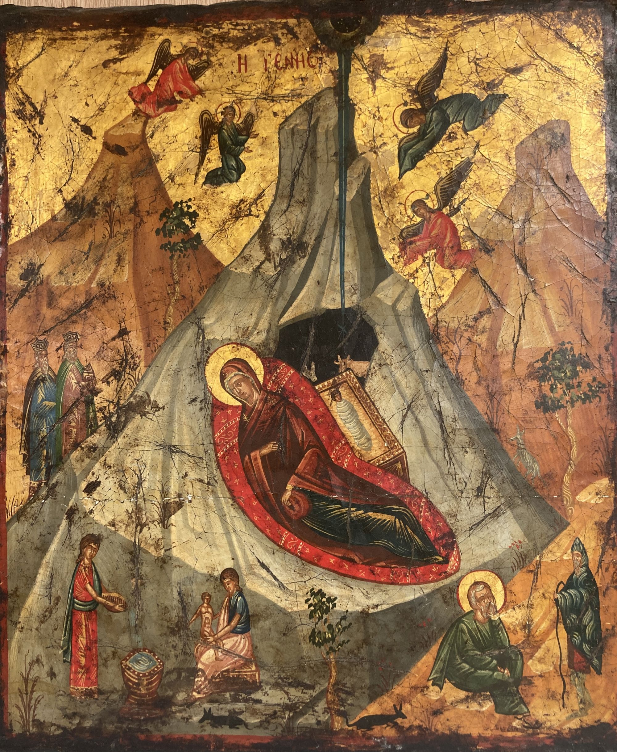 A 19th century tempera on panel icon, Virgin and child beneath a mountain with attendant figures, 36 x 30cm
